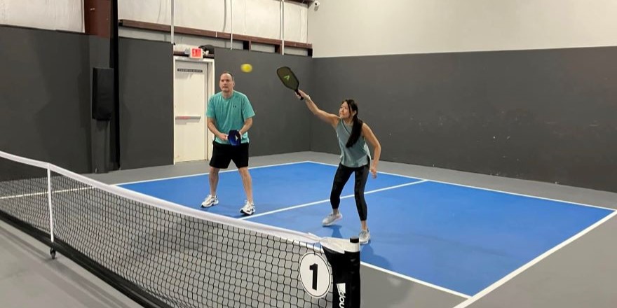 Players enjoying Open Play on an indoor pickleball court